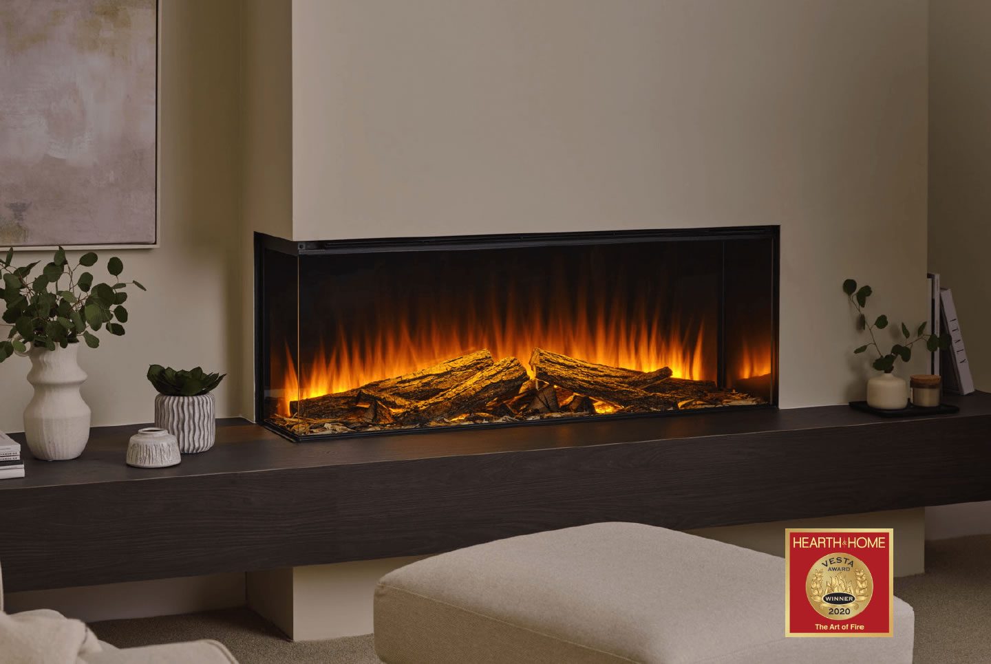 Modern electric fireplace with glowing flames and a sleek black finish, set in a cosy room.