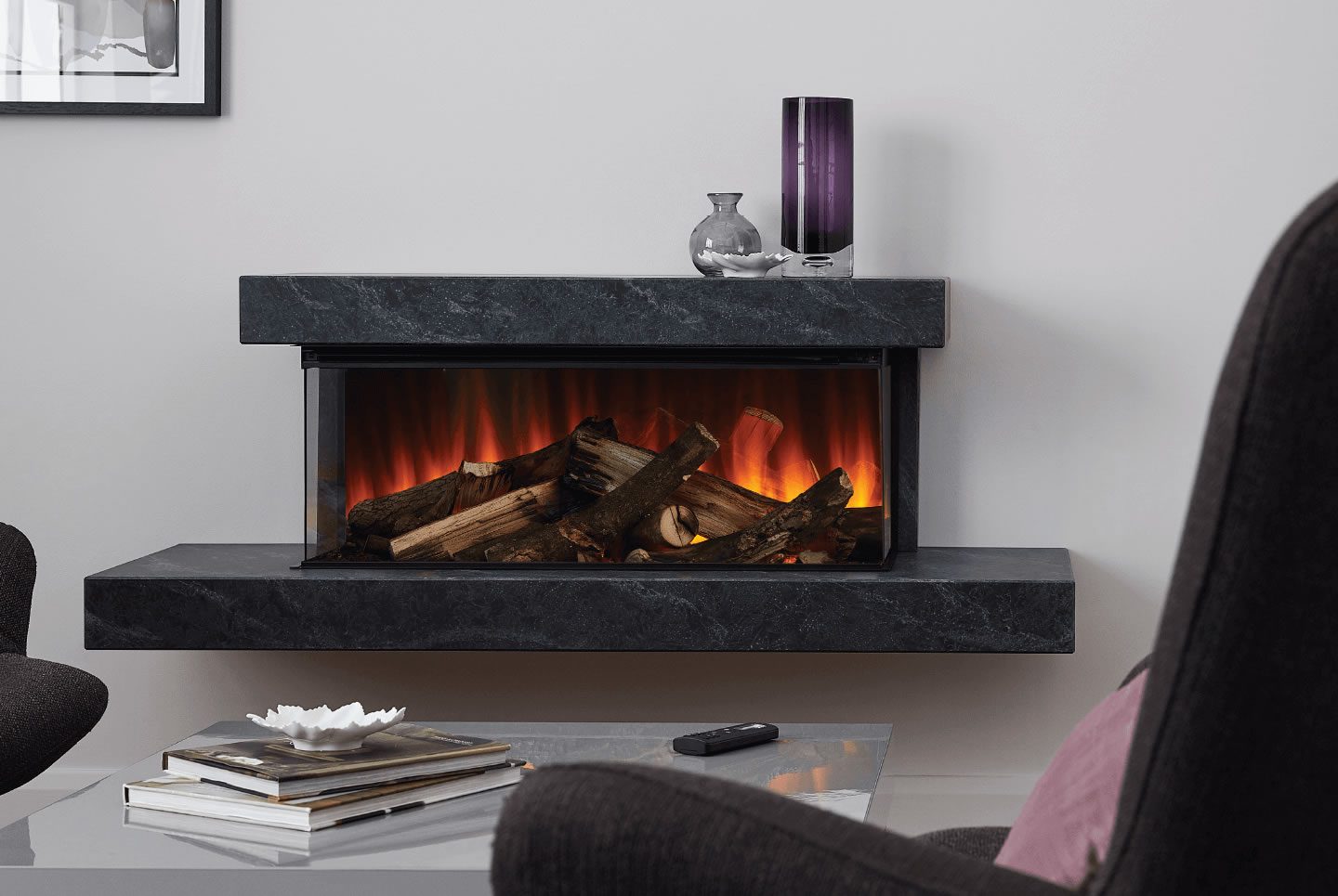 Modern room featuring a sleek electric fireplace with glowing logs and stylish decor. brockenhurst suite in grey