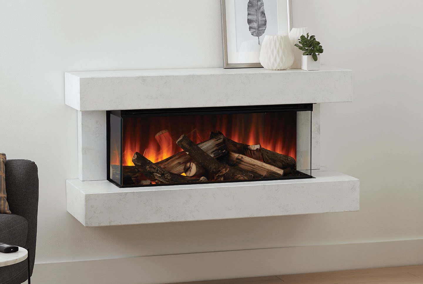 Modern electric fireplace with logs, surrounded by a white minimalist frame.