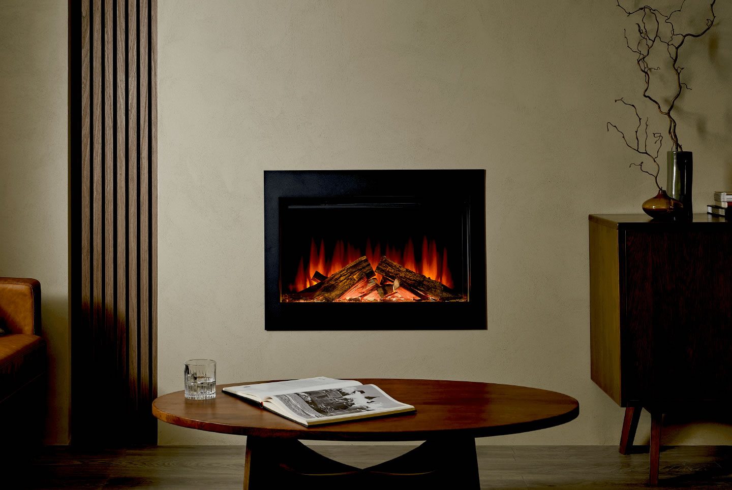 Modern fireplace with glowing embers, set against a neutral wall and stylish furniture.